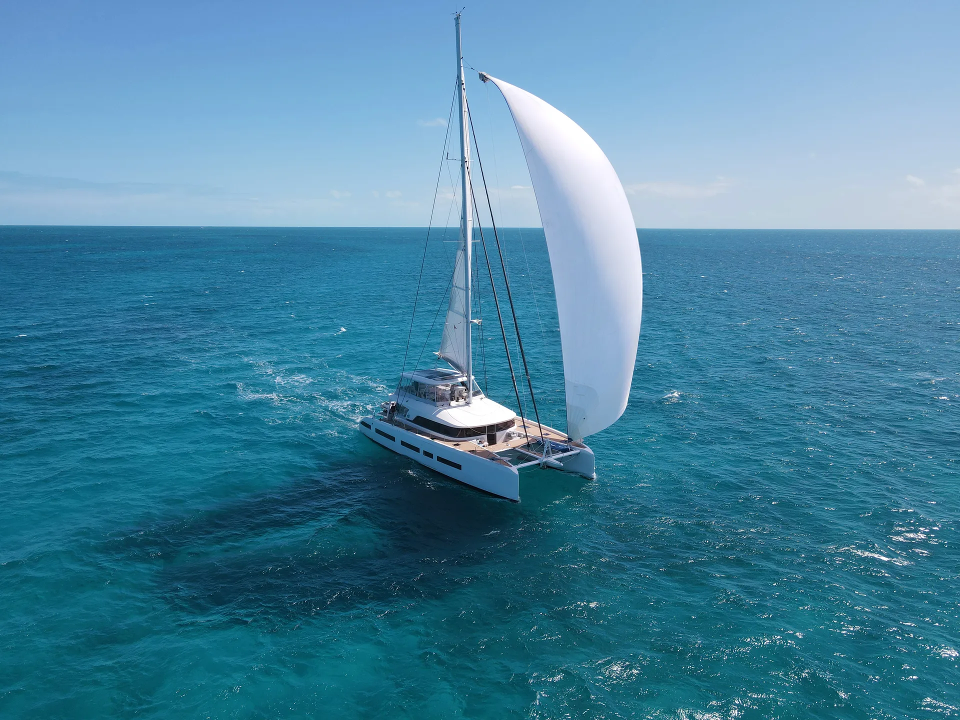 Lagoon Seventy 7 — Manaia — sailing under gennaker over turquoise water